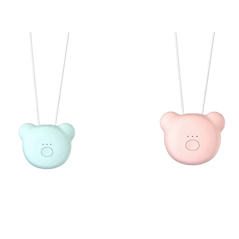 Small pink wearable USB air purifier necklace on a person, showing compact size.