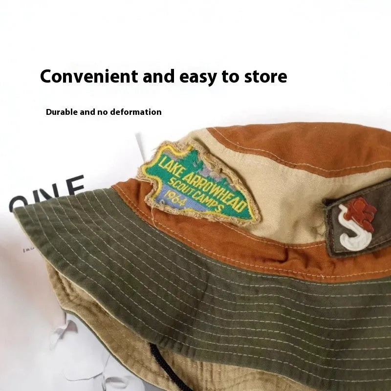 Army green cotton fisherman hat with patchwork detail and flat top crown on a neutral background.