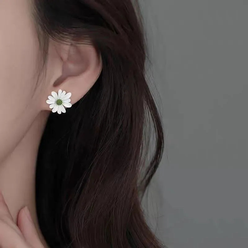 Cartoon flower stud earrings in blue and orange, white and green, or yellow and white alloy construction