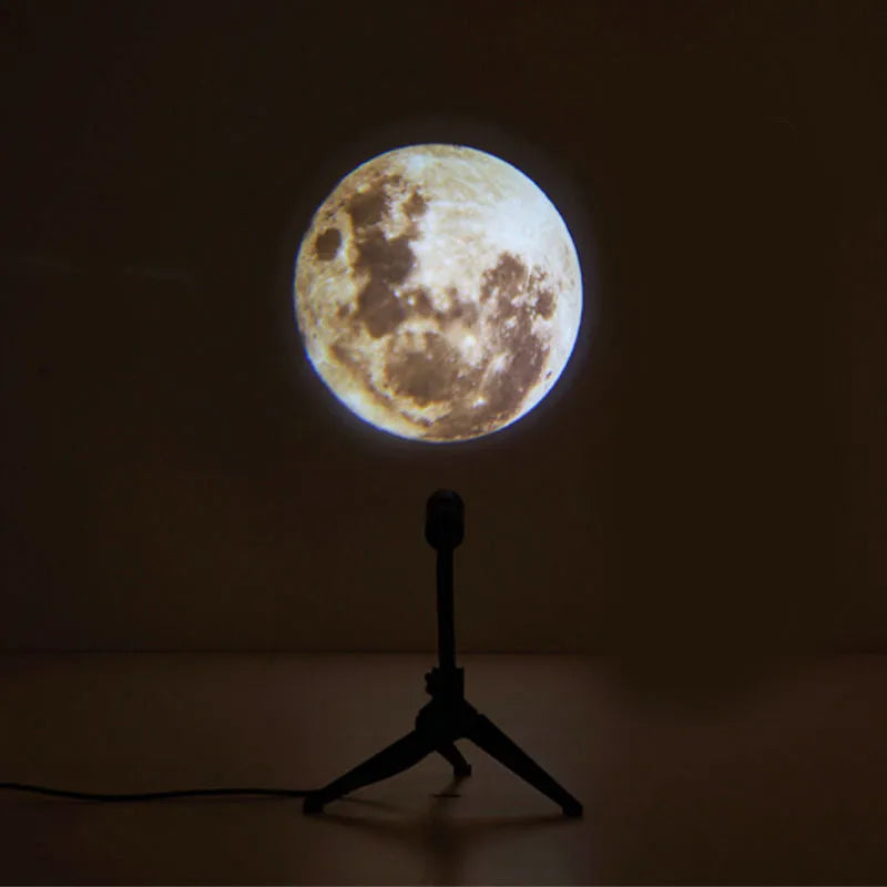 Earth and moon projection lamp with adjustable bracket on wooden surface