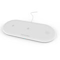White three-in-one wireless charging station for Apple iPhone, iWatch and headphones on a desk.