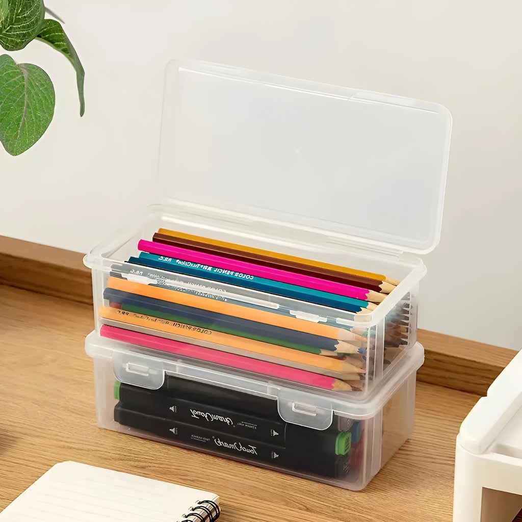 Transparent plastic pencil storage box full of coloured pencils and crayons