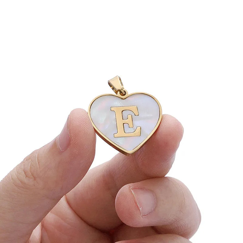 Gold-plated heart necklace with white shell centre on an adjustable stainless steel chain.