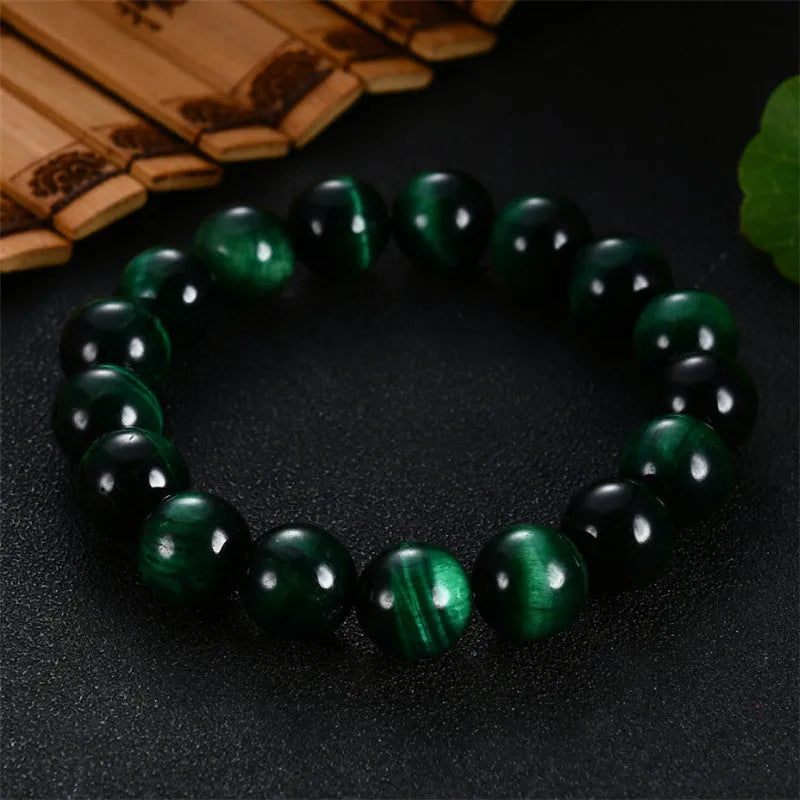 Polished green tiger eye stone bracelet with geometric beads on a wrist, showing size options.