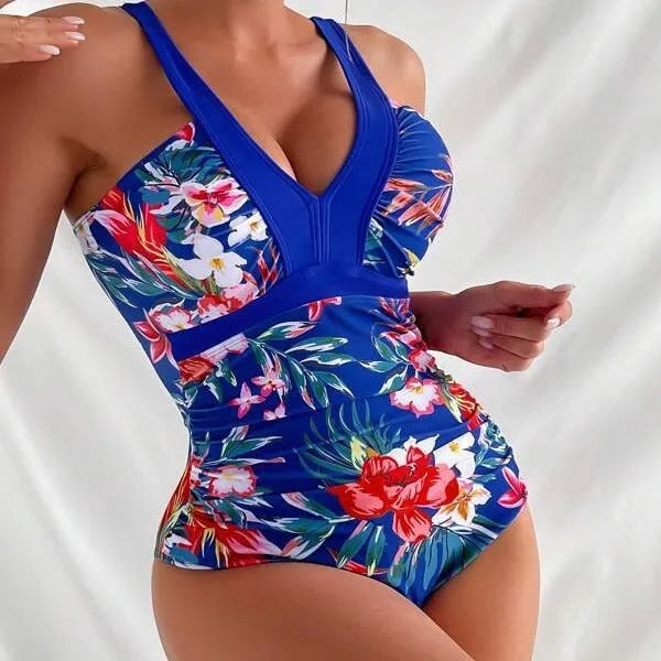 Women's floral print backless one-piece swimsuit on a hanger.