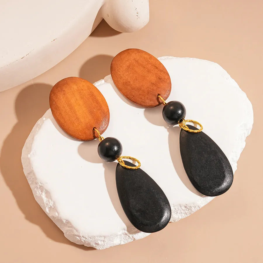 Brown-black wooden elliptical earrings with retro European-American style and silver needle detailing