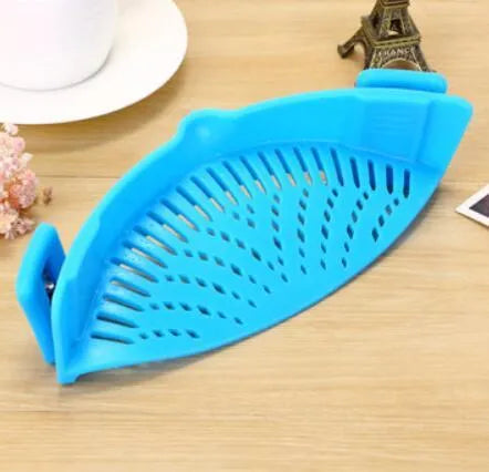 Silicone clip-on kitchen strainer attached to pot rim draining liquid