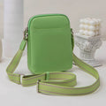 Women's solid colour PU crossbody shoulder bag showing compact dimensions and adjustable strap