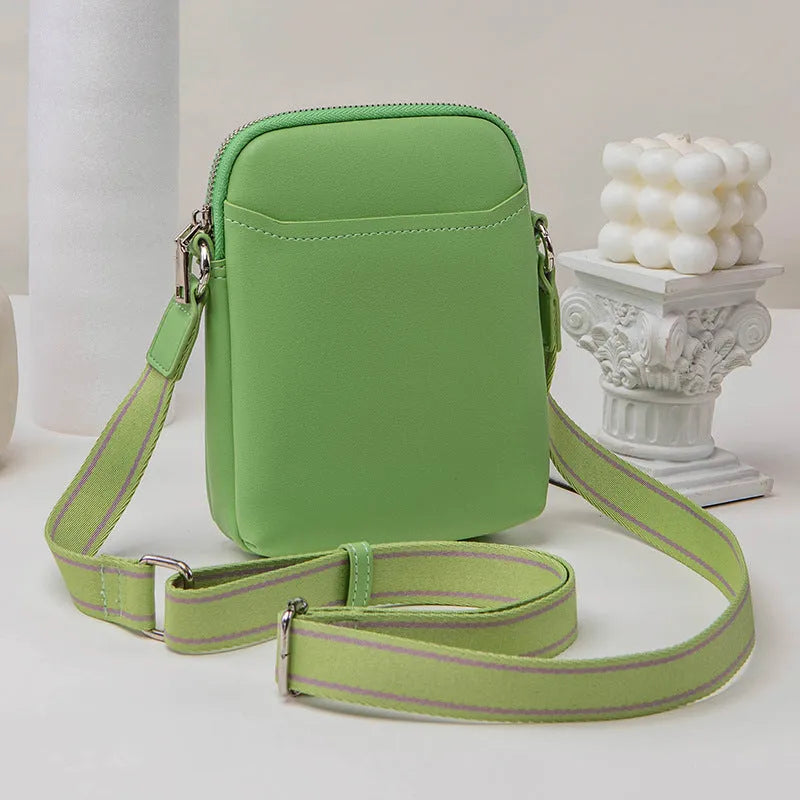 Women's solid colour PU crossbody shoulder bag showing compact dimensions and adjustable strap