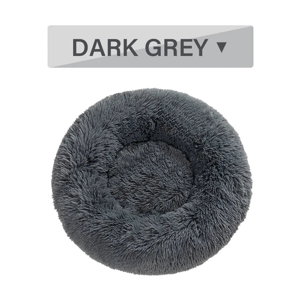 Fluffy donut-shaped dog bed with raised rim in plush fabric, available in multiple colours and four sizes