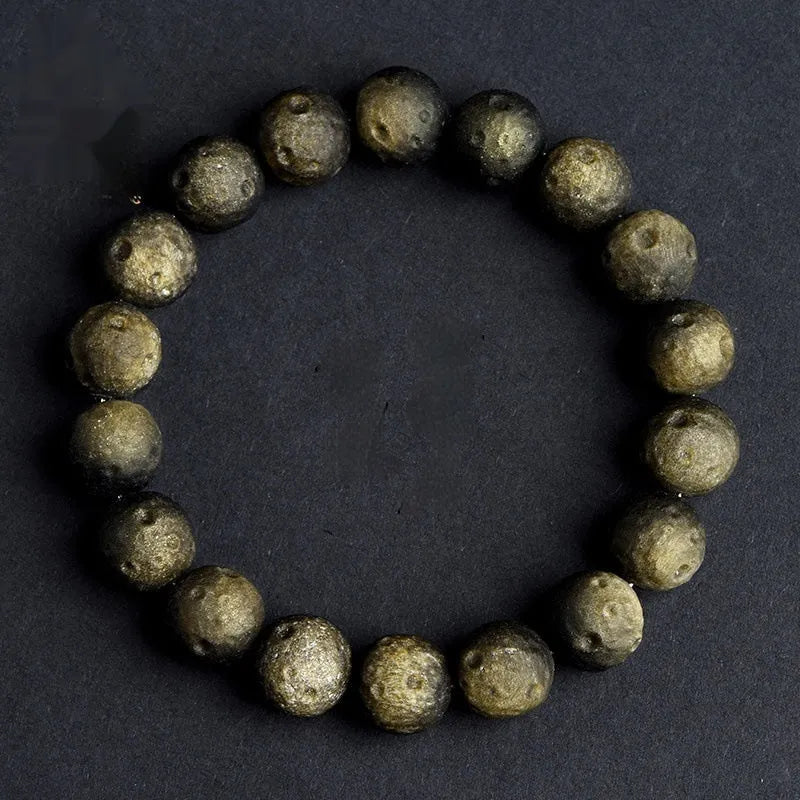 Obsidian meteorite crater ball bracelet with polished stones on adjustable string