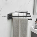 Nordic style folding towel rack in black mounted on bathroom wall with towels