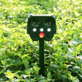 Green solar-powered ultrasonic animal repeller unit for outdoor pest control.