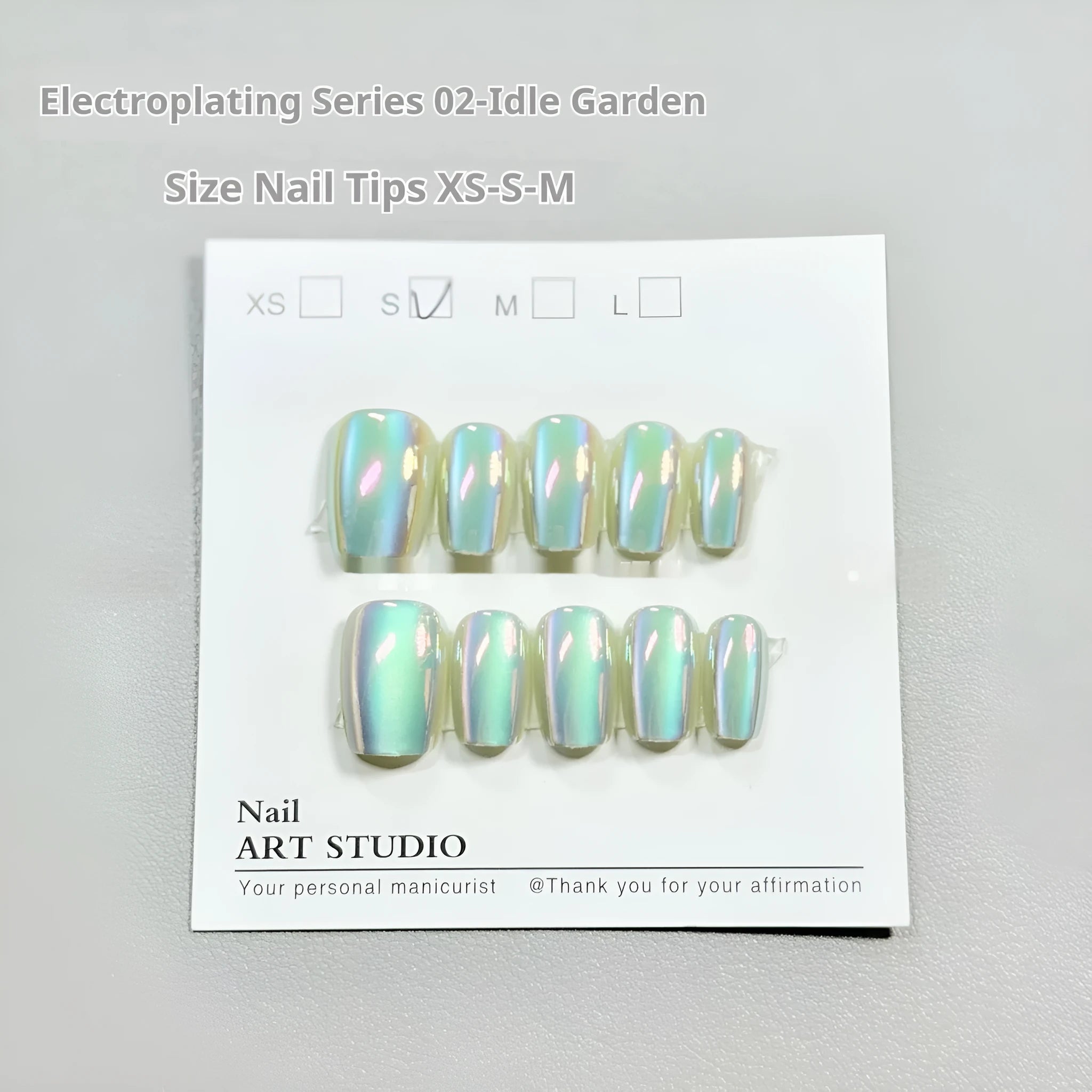 Set of electroplated Cat's Eye false nails showing Aurora armour and solid colour finishes on a hand.