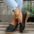 Women's black PU leather loafers with white car stitch detailing and a rubber sole.