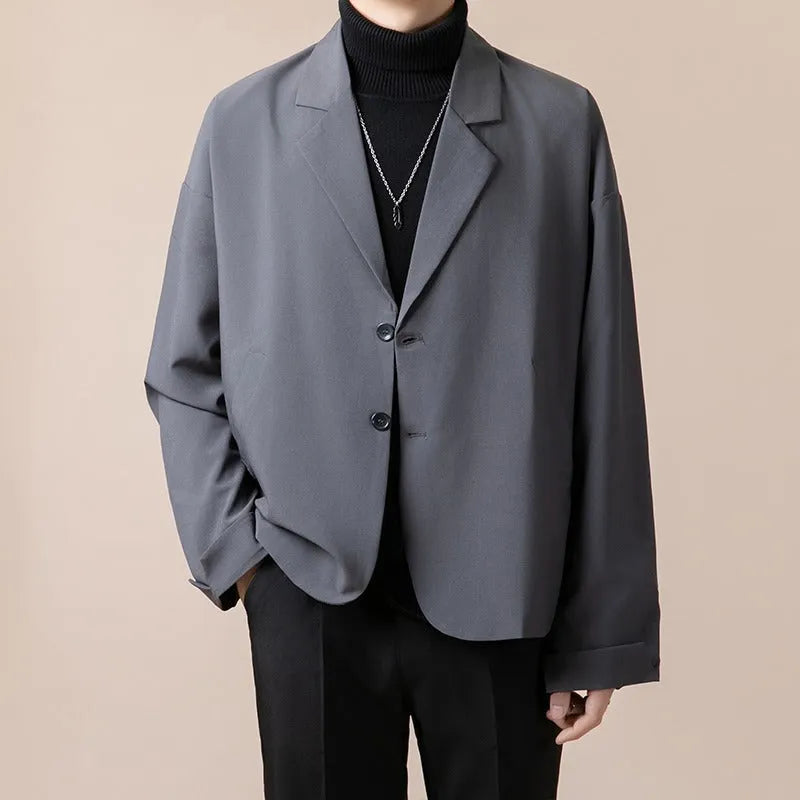 Men's loose fit casual suit jacket in a polyester blend fabric, shown in a light business style.