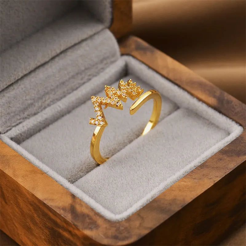 Korean fashion women's open geometric ring in electroplated gold colour on a plain background.