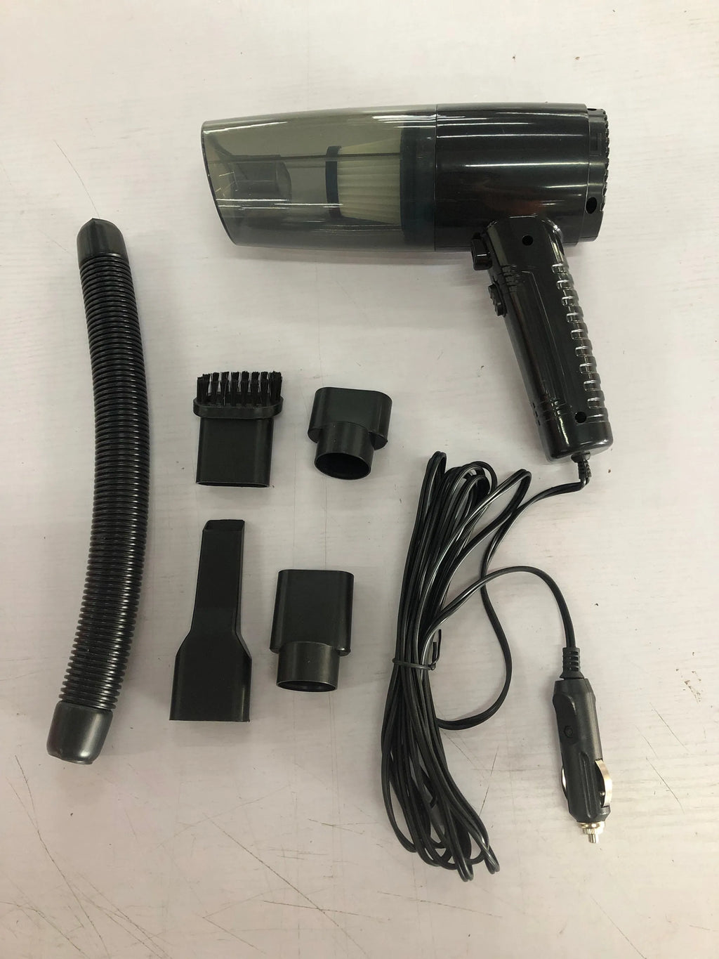 Black handheld car vacuum cleaner with accessories on 5 metre cord for 12V vehicle and home use