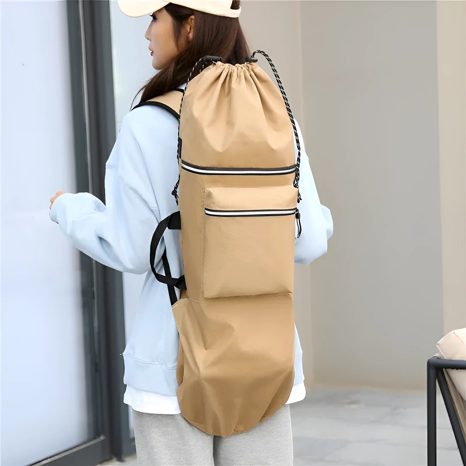 Black waterproof nylon skateboard bag with longboard fishing rod and flippers inside