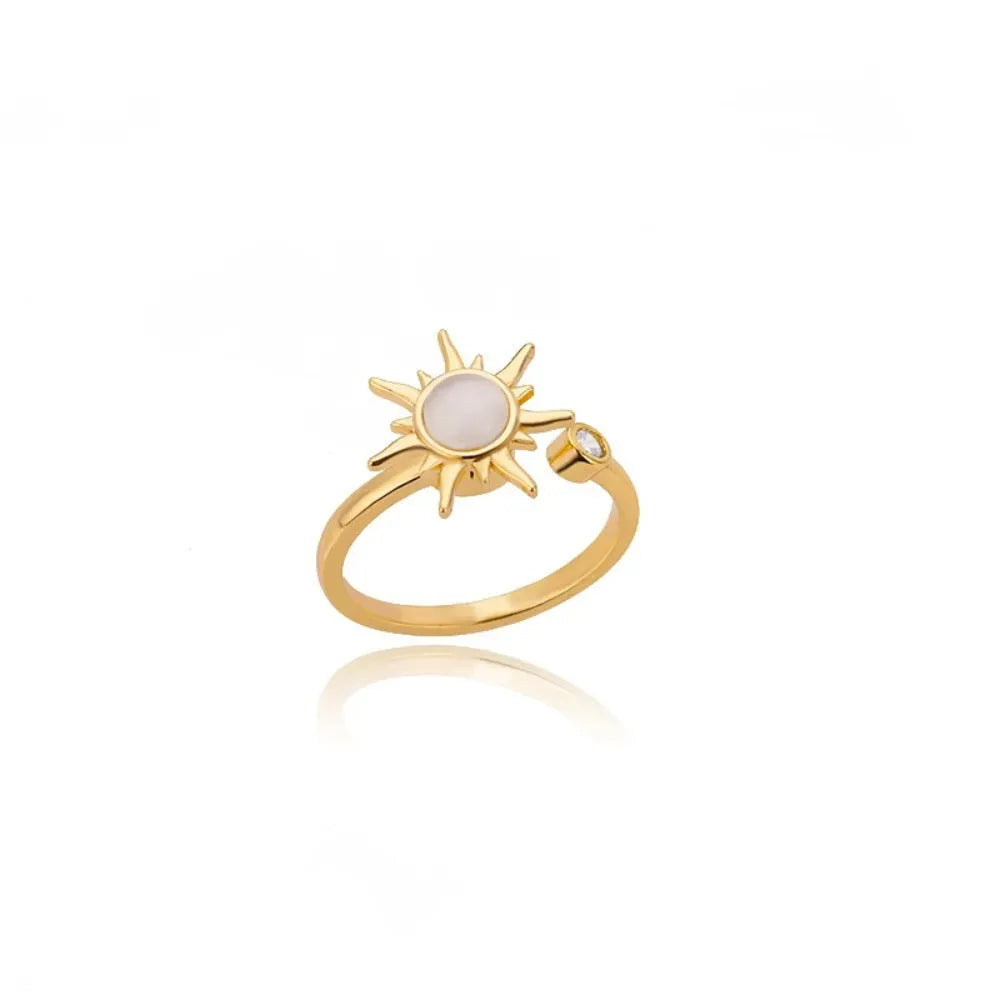 Gold and platinum adjustable open-mouth decompression ring with rotatable geometric component.