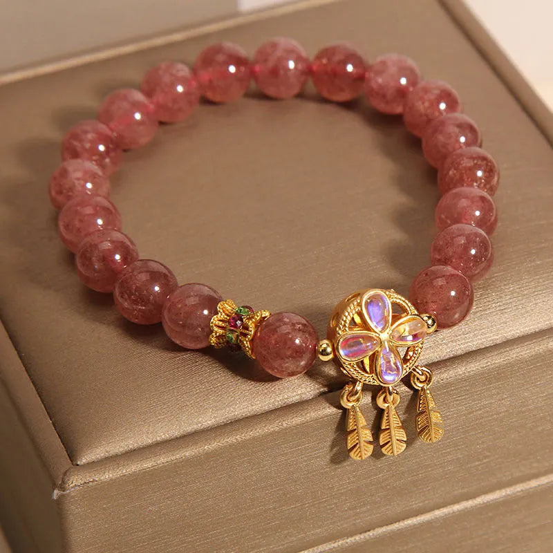 Natural strawberry quartz bracelet for women with a four-leaf dream catcher pendant on an adjustable chain.