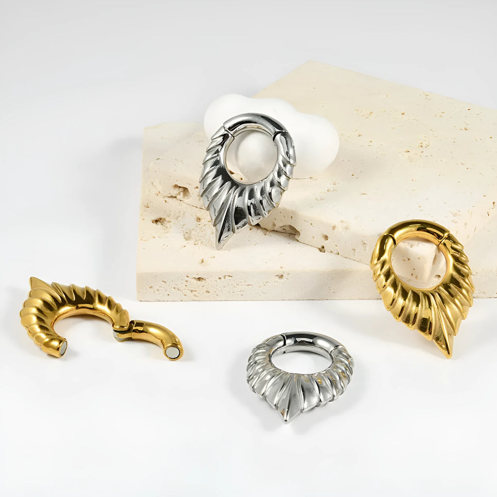Stainless steel drop-shaped ear extender with totem design on a white background.