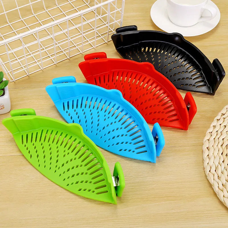 Silicone clip-on kitchen strainer attached to pot rim draining liquid
