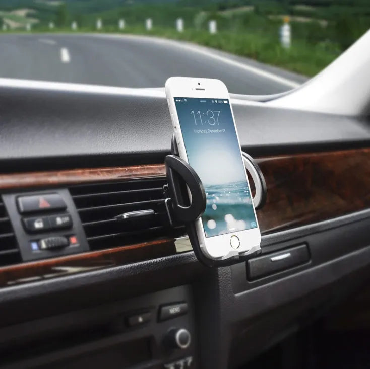 Black plastic car air conditioning vent mobile phone holder mounted on vehicle dashboard