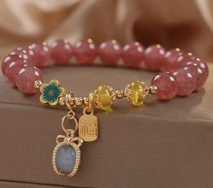 Red women's beaded bracelet with natural strawberry quartz stones, alloy metal, and rhinestone details.