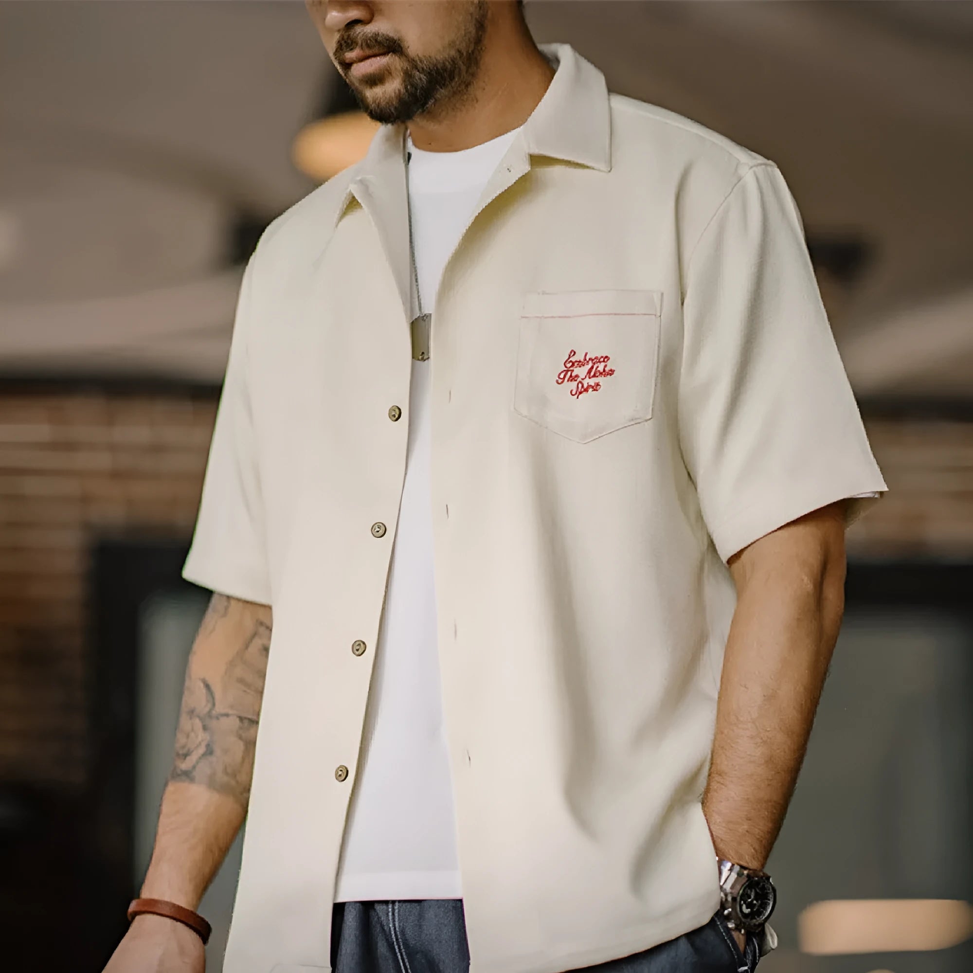 Light apricot coloured men's shirt with a bamboo and floral pattern and a Cuban collar.