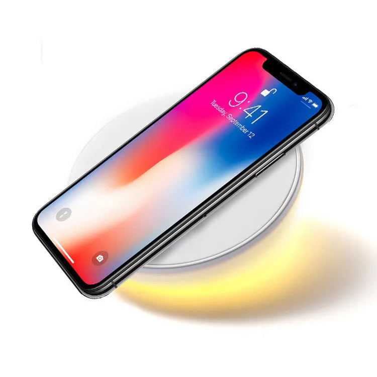 White QI wireless phone charger with digital clock display and three control buttons.
