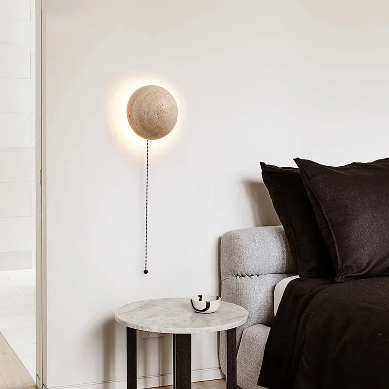 Vintage semicircle wall lamp with yellow cave stone shade and iron base, showing pull switch.