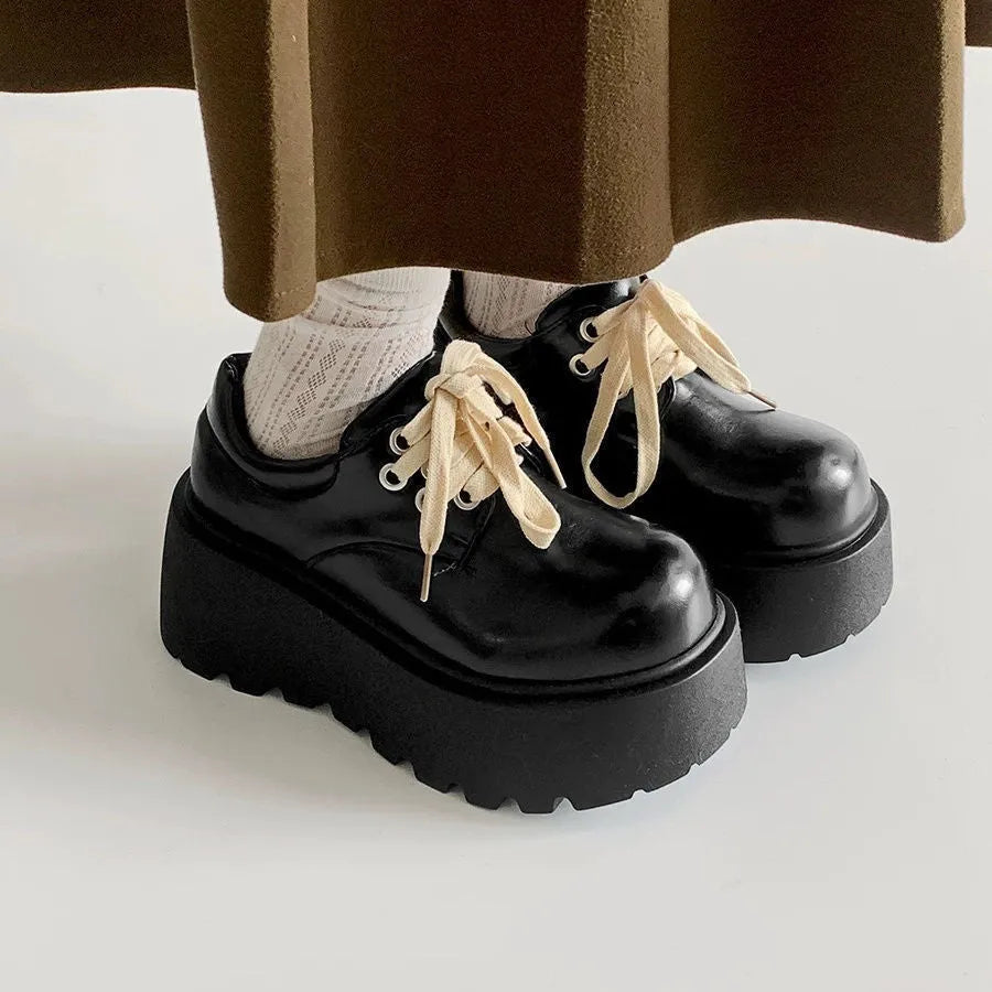 Women's matte black retro lace-up shoes with thick rubber sole and block heel.