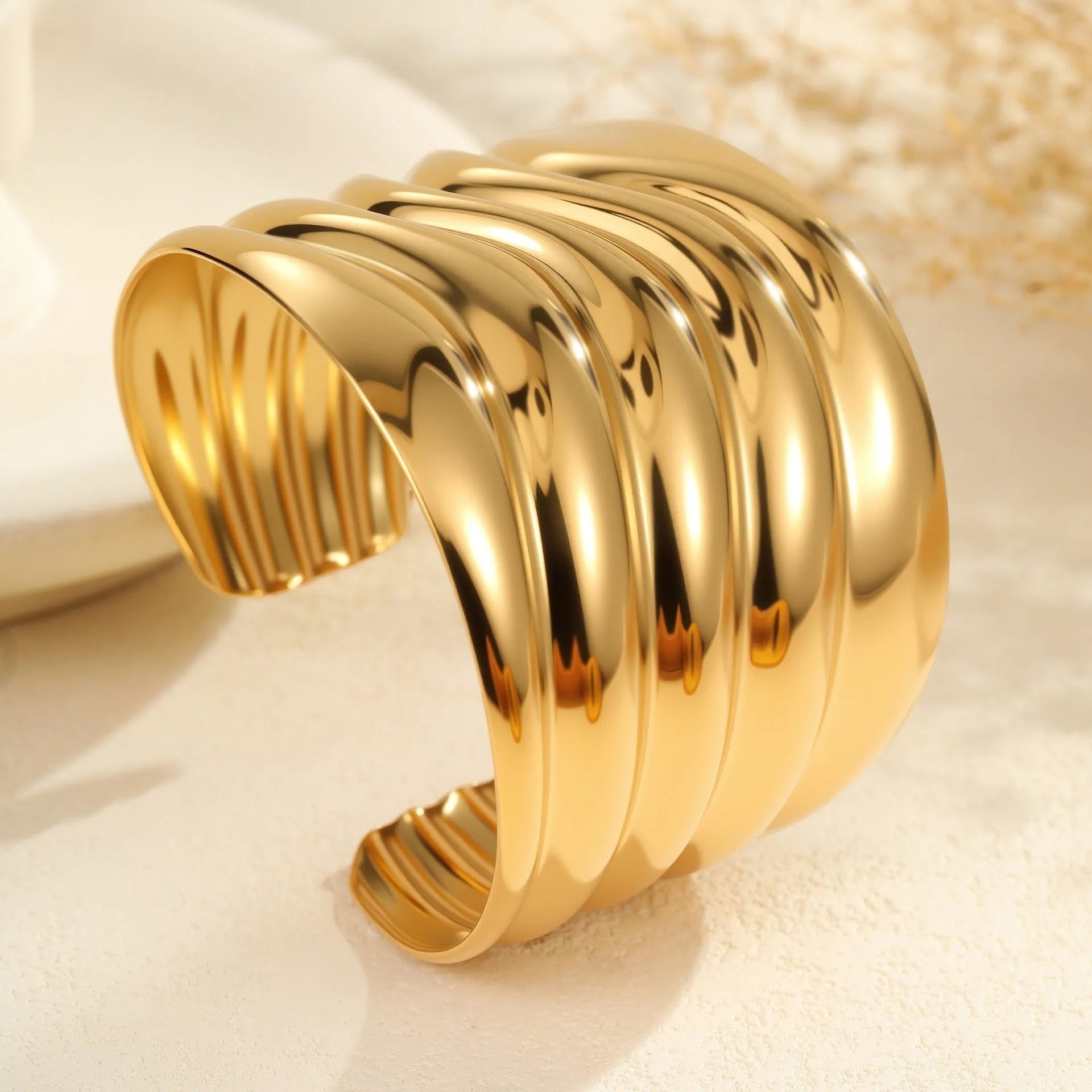 Women's wide fashion bracelet with gold plating and geometric wave design