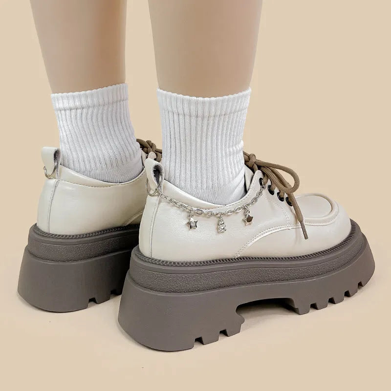 White platform Mary Jane shoes with chunky heel and front lace-up, featuring XINGX bear design.
