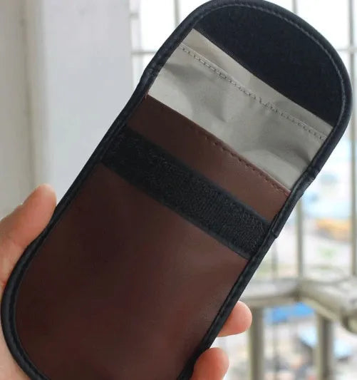 Black microfibre faraday cage bag for blocking car key, phone and RFID card signals.