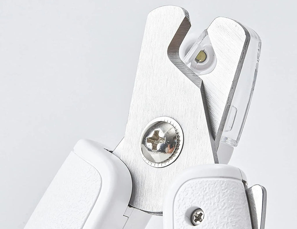 White LED pet nail clippers for dogs and cats with a transparent safety guard and leather-like handle.