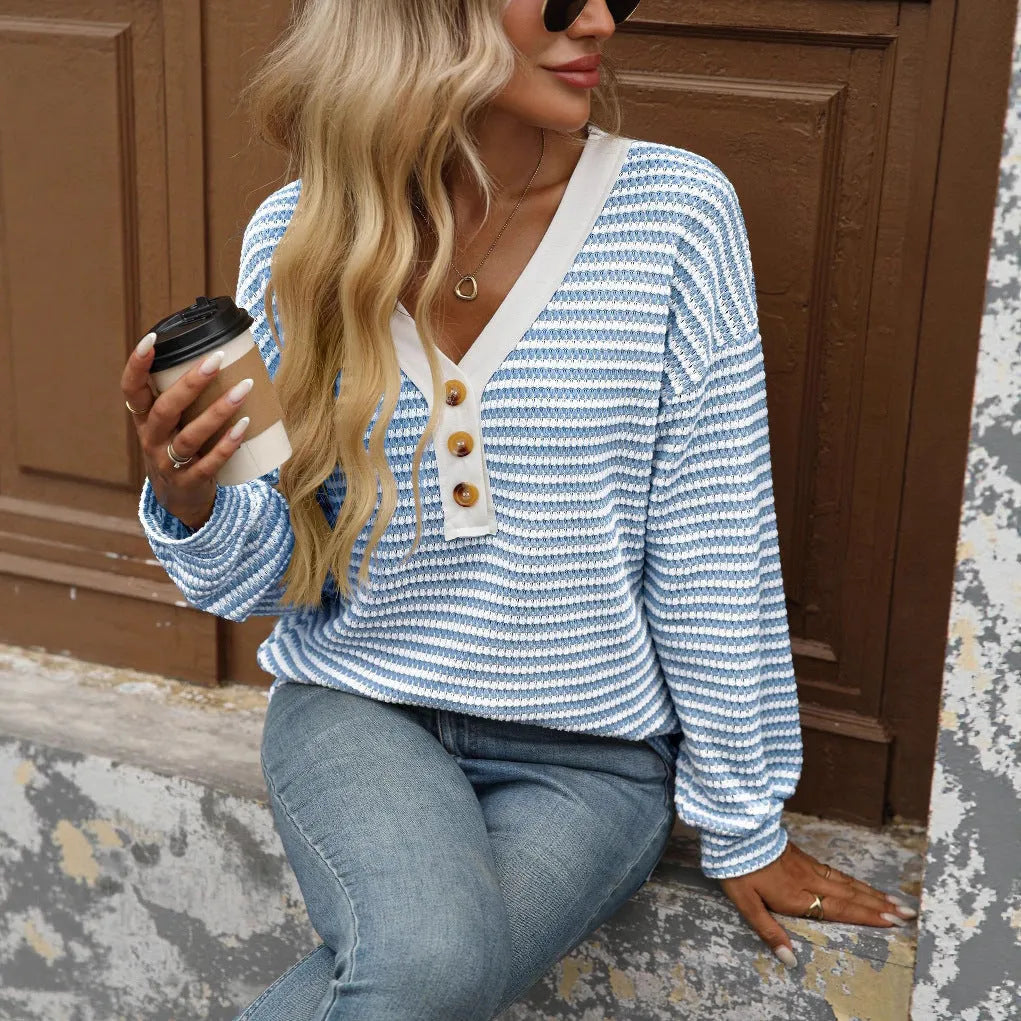 Women's loose-fitting apricot V-neck pullover top with button detail and patchwork design on long sleeves.