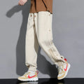 Men's black loose-fit cotton blend sweatpants with ankle ties and a drawstring waist.