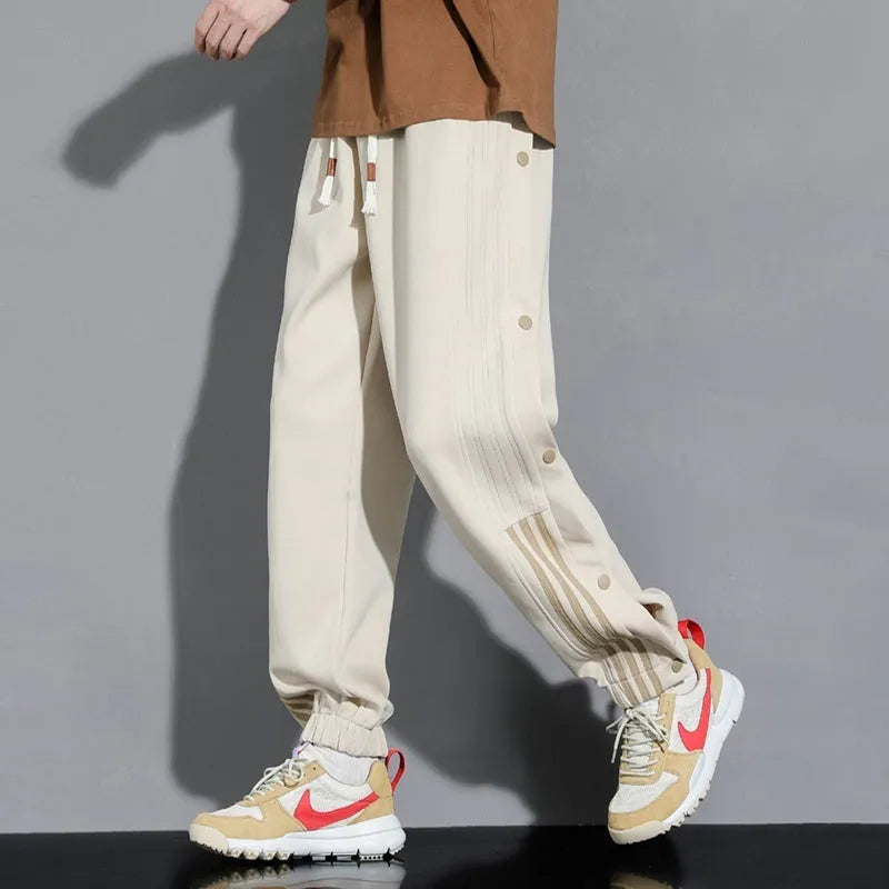 Men's black loose-fit cotton blend sweatpants with ankle ties and a drawstring waist.