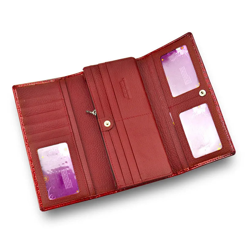Women's patent leather purse with crocodile pattern in red colour showing pigskin lining interior