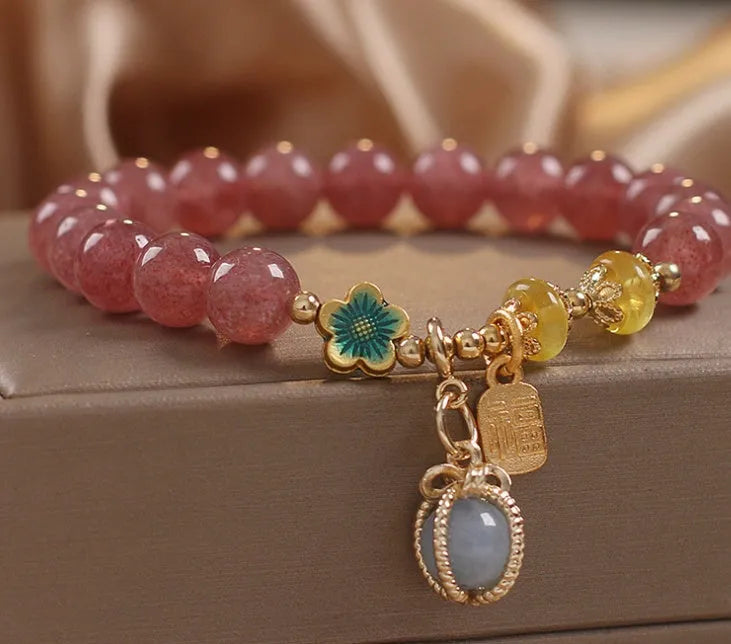 Red women's beaded bracelet with natural strawberry quartz stones, alloy metal, and rhinestone details.