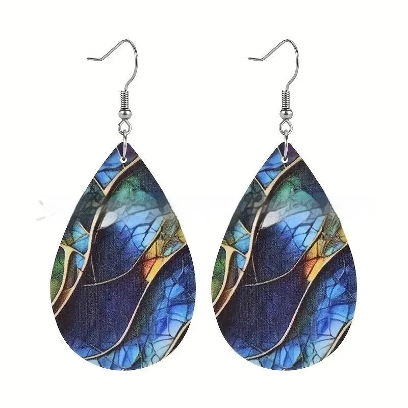 A pair of drop-shaped acrylic earrings featuring a printed flat branch knot design.