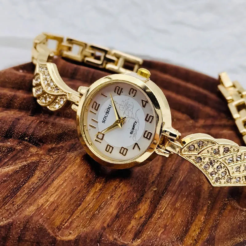 Stainless steel women's watch with round dial on wrist, showing Vachette clasp buckle