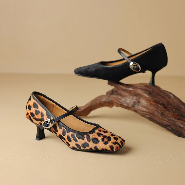 Women's black square toe stiletto heel ankle-strap shoes with horse hair upper and buckle closure.