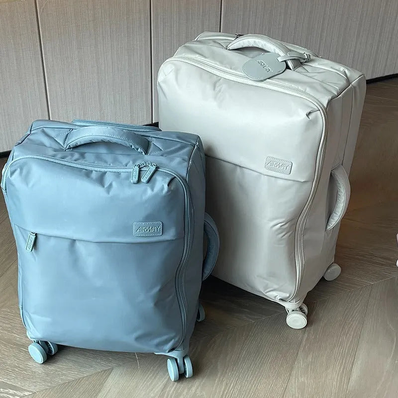Ultra-light waterproof Oxford cloth suitcase in bluestone green with universal wheels, 20-inch size shown.