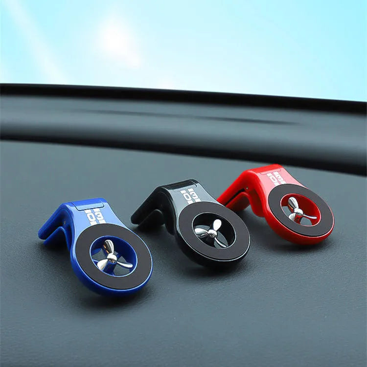 Black magnetic car phone holder attached to vehicle air vent with smartphone mounted