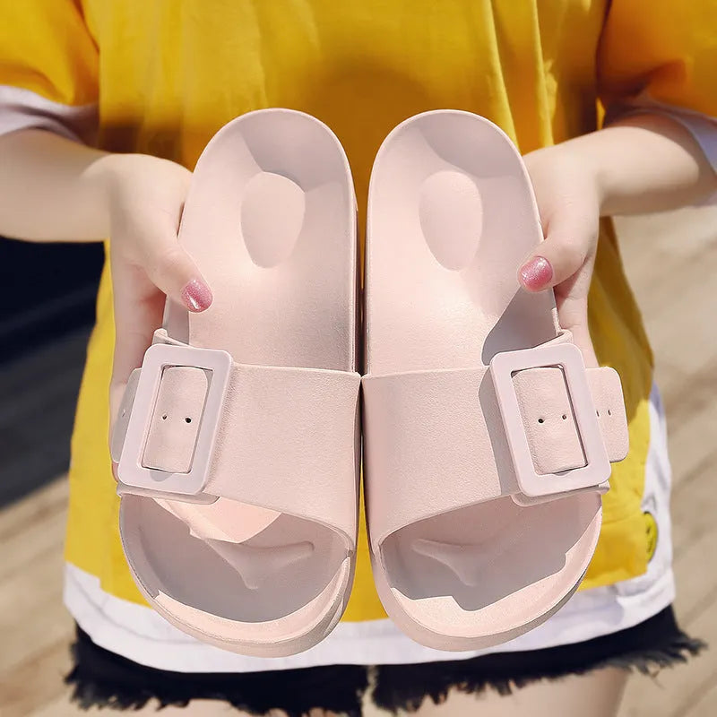 Women's grey blue flip-flop slippers with a buckle fastening on a white background