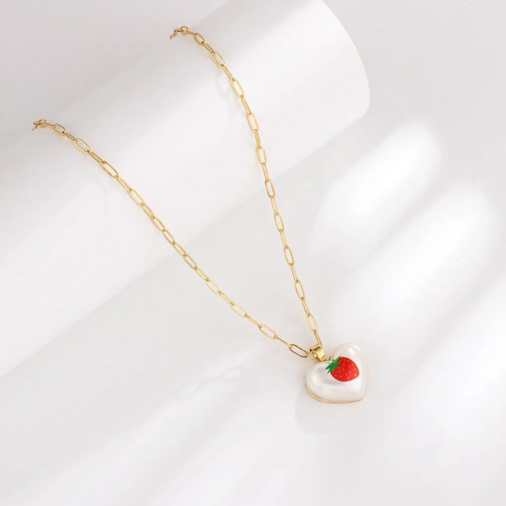 Adjustable chain necklace with a choice of geometric fruit pendant charms: apple, cherry, pear, pineapple, or strawberry.