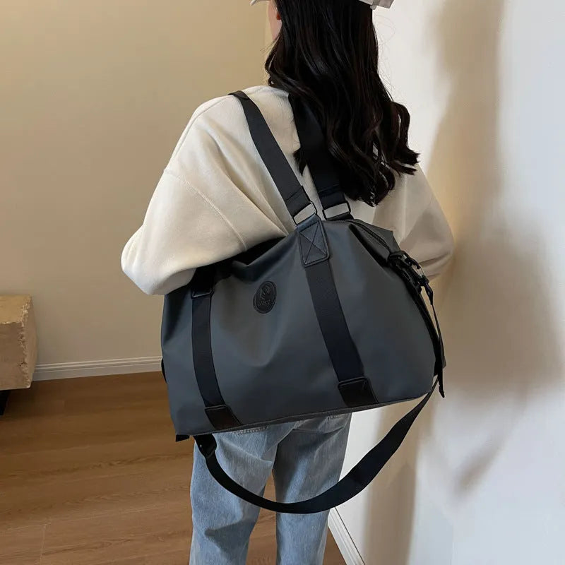 Waterproof Oxford cloth travel bag in solid colour with breathable back panel and 36-55L capacity